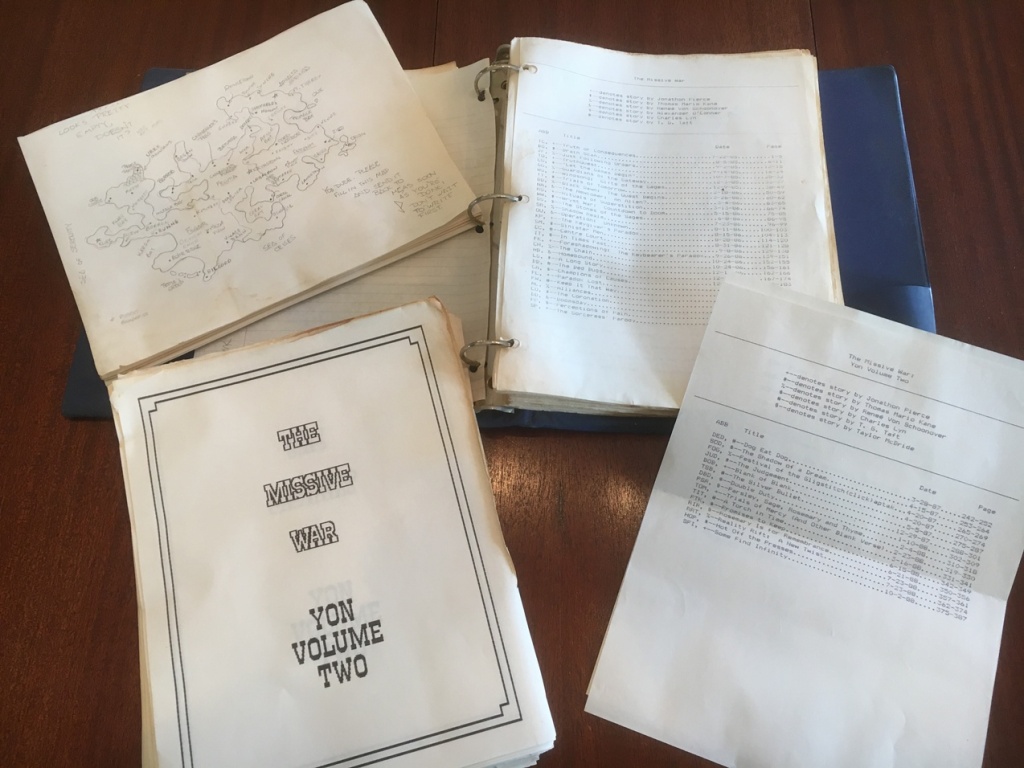 A blue, three-ring binder with dot matrix printed pages is overlaid by a hand-drawn map in pencil, a stack of story pages and a table of contents.